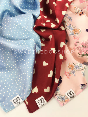Take an advantage of 3 for $30 deal. 3 Blue/Red/Pink Color Theme Swagdana Scarves displayed. 1-Polka Itty Bitty Powdered Blue. 2-Full of Heart Burgundy Cream. 3-Pink Wild Flower. Dog Bandana. Dog Scarf