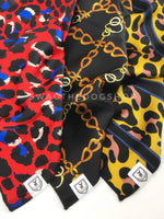 Take an advantage of 3 for $30 deal. 3 Red/ Black/ Yellow color theme Swagdana Scarves displayed. 1-Fierce Vibrant Red with Blue. 2-24K Black Gold. 3-Leopard Sunflower Yellow. Dog Bandana. Dog Scarf