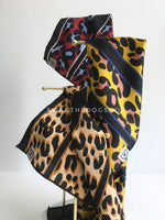 Take an advantage of 3 for $30 deal. 3 Leopard Print Swagdana Scarves displayed hanging. 1-Leopard Burgundy. 2-Leopard Sunflower Yellow. 3-Leopard Camel. Dog Bandana. Dog Scarf