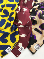 Take an advantage of 3 for $30 deal. 3 Yellow/ Red/ Beige color theme Swagdana Scarves displayed. 1-Full of Heart Royal Yellow. 2-Lorenzo Llama Burgundy. 3-Fierce Beige with Purple. Dog Bandana. Dog Scarf